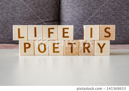 motivational phrase Life Is Poetry made of letters on wooden cubes motivational phrase Life Is Poetry made of letters on wooden cubes 141368633