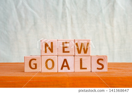 motivational phrase New Goals made of letters on wooden cubes motivational phrase New Goals made of letters on wooden cubes 141368647