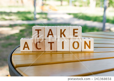 motivational phrase Take Action made of letters on wooden cubes motivational phrase Take Action made of letters on wooden cubes 141368658