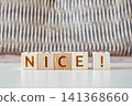 motivational word Nice! made of letters on wooden cubes 141368660