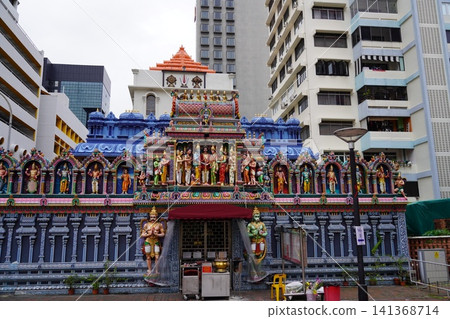 Colorful Hindu Temple Architecture Amidst Urban Buildings Colorful Hindu Temple Architecture Amidst Urban Buildings 141368714