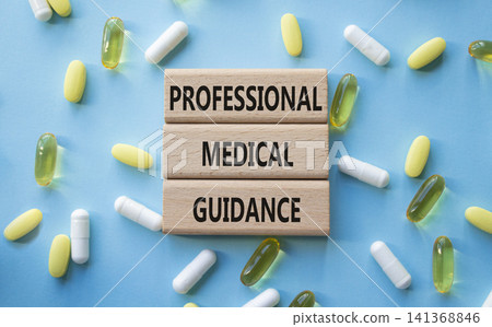 PROFESSIONAL MEDICAL GUIDANCE symbol. Concept words PROFESSIONAL MEDICAL GUIDANCE on wooden blocks. Beautiful blue background with pills. Healthcare and PROFESSIONAL MEDICAL GUIDANCE concept. Copy PROFESSIONAL MEDICAL GUIDANCE symbol. Concept words PROFESSIONAL MEDICAL GUIDANCE on wooden blocks. Beautiful blue background with pills. Healthcare and PROFESSIONAL MEDICAL GUIDANCE concept. Copy 141368846