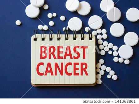 Breast cancer symbol. Concept word Breast cancer on notebook. Beautiful deep blue background with pills. Medicine and Breast cancer concept. Copy space Breast cancer symbol. Concept word Breast cancer on notebook. Beautiful deep blue background with pills. Medicine and Breast cancer concept. Copy space 141368861