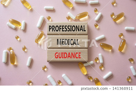 PROFESSIONAL MEDICAL GUIDANCE symbol. Concept words PROFESSIONAL MEDICAL GUIDANCE on wooden blocks. Beautiful pink background with pills. Healthcare and PROFESSIONAL MEDICAL GUIDANCE concept. Copy PROFESSIONAL MEDICAL GUIDANCE symbol. Concept words PROFESSIONAL MEDICAL GUIDANCE on wooden blocks. Beautiful pink background with pills. Healthcare and PROFESSIONAL MEDICAL GUIDANCE concept. Copy 141368911