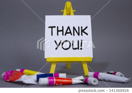 Thank you symbol. Wooden blocks with words Thank you. Beautiful grey background with paints and easel. Business and Thank you concept. Copy space. Thank you symbol. Wooden blocks with words Thank you. Beautiful grey background with paints and easel. Business and Thank you concept. Copy space. 141368926