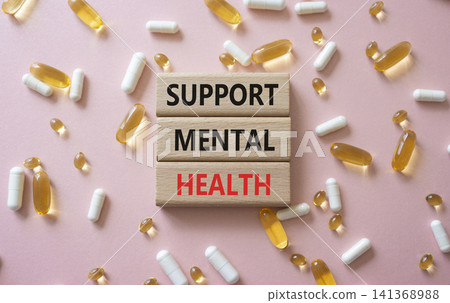 Support Mental Wellness symbol. Concept words Support Mental Wellness on wooden blocks. Beautiful pink background with pills. Healthcare and Support Mental Wellness concept. Copy space. Support Mental Wellness symbol. Concept words Support Mental Wellness on wooden blocks. Beautiful pink background with pills. Healthcare and Support Mental Wellness concept. Copy space. 141368988