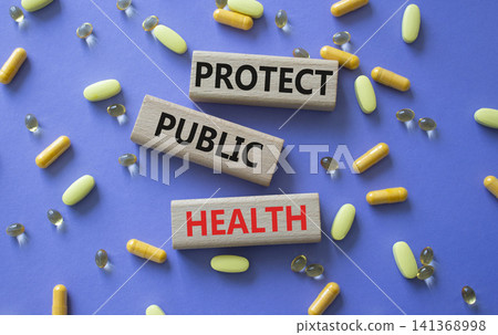 Protect Public Health symbol. Concept words Protect Public Health on wooden blocks. Beautiful purple background with pills. Healthcare and Protect Public Health concept. Copy space. Protect Public Health symbol. Concept words Protect Public Health on wooden blocks. Beautiful purple background with pills. Healthcare and Protect Public Health concept. Copy space. 141368998