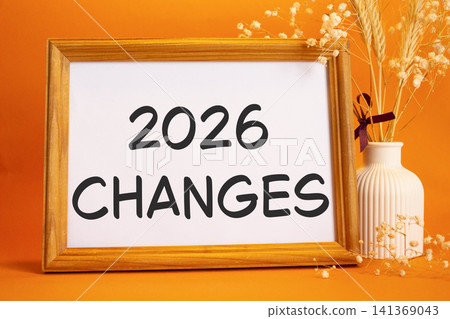 2026 Changes symbol. Concept words 2026 Changes on beautiful wooden picture frame. Beautiful orange background with flower vase. Business and 2026 Changes concept. Copy space. 2026 Changes symbol. Concept words 2026 Changes on beautiful wooden picture frame. Beautiful orange background with flower vase. Business and 2026 Changes concept. Copy space. 141369043