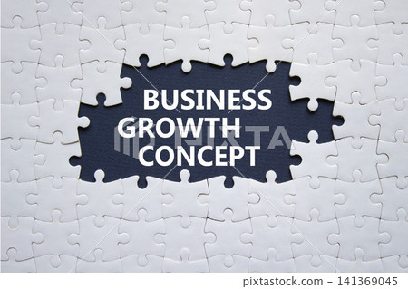 Business Growth Concept symbol. White puzzle with words Business Growth Concept. Beautiful deep blue background. Business concept. Copy space. Business Growth Concept symbol. White puzzle with words Business Growth Concept. Beautiful deep blue background. Business concept. Copy space. 141369045