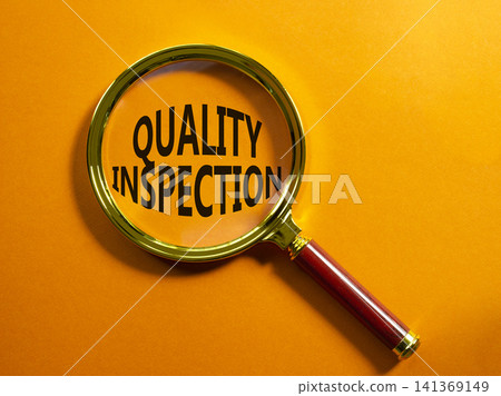 Quality Inspection symbol. Magnifying Glass with words Quality Inspection. Beautiful orange background. Business and Quality Inspection concept. Copy space. 141369149
