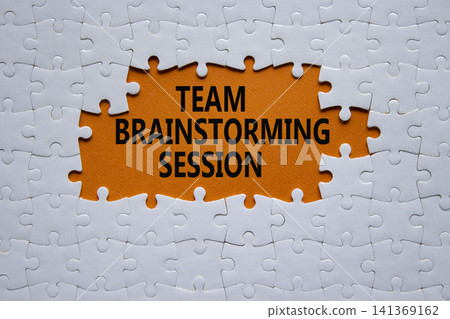 Team Brainstorming Session symbol. White puzzle with words Team Brainstorming Session. Beautiful orange background. Business concept. Copy space. Team Brainstorming Session symbol. White puzzle with words Team Brainstorming Session. Beautiful orange background. Business concept. Copy space. 141369162