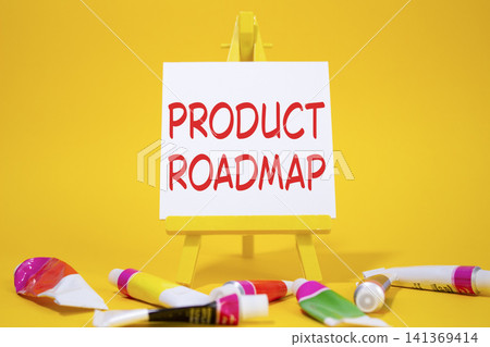 Product Roadmap symbol. Concept word Product Roadmap on wooden blocks. Beautiful yellow background with paints and easel. Business and Product Roadmap concept. Copy space Product Roadmap symbol. Concept word Product Roadmap on wooden blocks. Beautiful yellow background with paints and easel. Business and Product Roadmap concept. Copy space 141369414