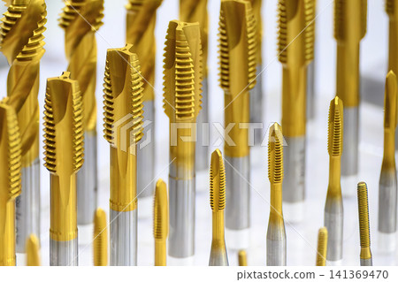 Close-up of a group of special coating tapping tools for small and big size threads for CNC milling machines. 141369470