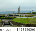 A commuter train running from Ichinoseki in Iwate Prefecture to Morioka passes through the rural landscape of Shiwa District. 141369890