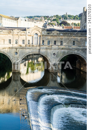 Historic honey-colored stone buildings and stone bridges: The cityscape of Bath, a UNESCO World Heritage Site in the UK. Historic honey-colored stone buildings and stone bridges: The cityscape of Bath, a UNESCO World Heritage Site in the UK. 141370103