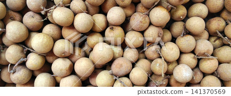 A full-frame photo showing the texture of a dense pile of fresh longan fruit. A full-frame photo showing the texture of a dense pile of fresh longan fruit. 141370569