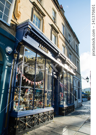 A shop window of a historic honey-colored stone building; the cityscape of Bath, a UNESCO World Heritage Site in the UK. A shop window of a historic honey-colored stone building; the cityscape of Bath, a UNESCO World Heritage Site in the UK. 141370601