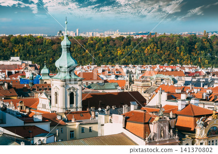 The green dome of St. Nicholas Church rising above Prague rooftops. The green dome of St. Nicholas Church rising above Prague rooftops. 141370802