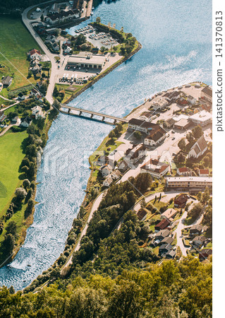 Aerial view of a coastal town and bridge along a fjord in Norway. Aerial view of a coastal town and bridge along a fjord in Norway. 141370813