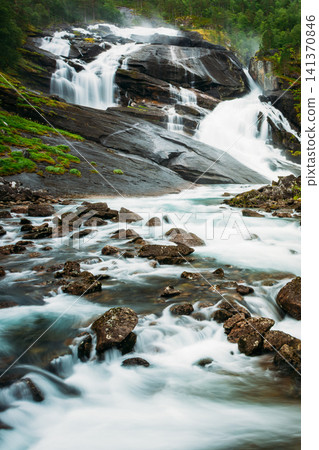 Rushing river rapids over rocks in Husedalen Valley. Rushing river rapids over rocks in Husedalen Valley. 141370846