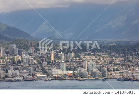 Cityscape view of North Vancouver from downtown Vancouver British Columbia Canada with bay of water and boats. Modern housing development. Travel photo, editorial. July 10,2022 141370935