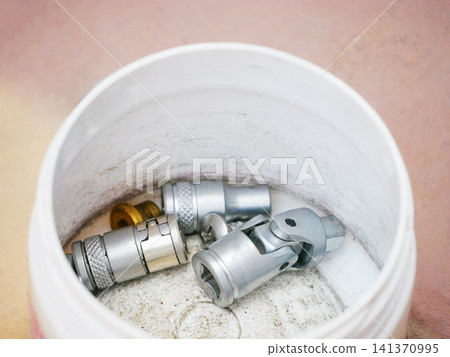 Metal socket set inside a white plastic container. Assorted steel tools for mechanical maintenance and automotive repair. Equipment for fixing hardware and mechanical engineering project. Metal socket set inside a white plastic container. Assorted steel tools for mechanical maintenance and automotive repair. Equipment for fixing hardware and mechanical engineering project. 141370995