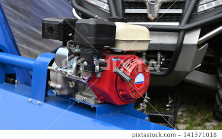 Engine mounted on blue motorized equipment Engine mounted on blue motorized equipment 141371018