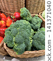 Fresh vegetables stacked in baskets at a market showcasing vibrant produce variety 141371040