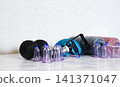 Tools for cupping therapy in a treatment room on a white table with gloves and plants present 141371047