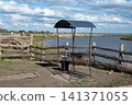 Riverside shelter with a water fountain in a rural area near the riverbank on a sunny day 141371055
