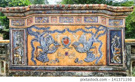 Phoenixs Carved On Screen Wall In A Emperor Mausoleum In Hue Ancient Capital, Vietnam. Phoenixs Carved On Screen Wall In A Emperor Mausoleum In Hue Ancient Capital, Vietnam. 141371198
