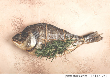 hot smoked dorado fish, with a sprig of rosemary, tied with a rope, on the table, top view, smoked fish, close-up, no people, 141371242