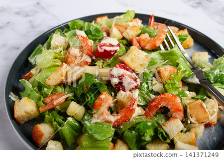 Caesar salad, with shrimp, on a marble background, top view, no people, 141371249