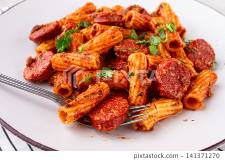 rigatoni pasta with spicy sausage, and rich tomato sauce served, on a white plate, homemade, rigatoni pasta with spicy sausage, and rich tomato sauce served, on a white plate, homemade, 141371270
