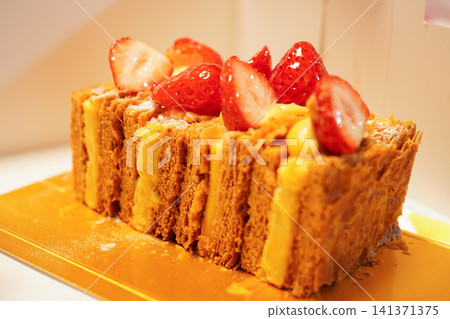 A luxurious strawberry Napoleon pastry served on a gold tray. A luxurious strawberry Napoleon pastry served on a gold tray. 141371375