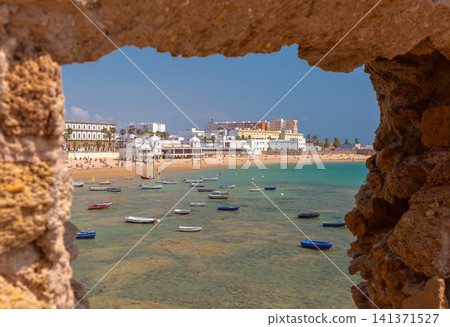 View of La Caleta Beach through fortress wall in Cadiz, Andalusia, Spain View of La Caleta Beach through fortress wall in Cadiz, Andalusia, Spain 141371527