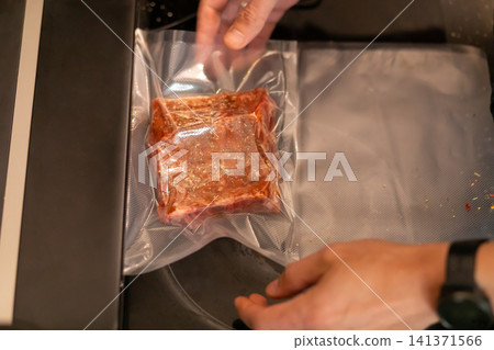 Chef Holding Vacuum Sealed Marinated Pork Rib Near Sealer Chef Holding Vacuum Sealed Marinated Pork Rib Near Sealer 141371566