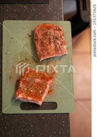 Close Up Raw Pork Rib Piece Covered in Red Paprika Rub Close Up Raw Pork Rib Piece Covered in Red Paprika Rub 141371629