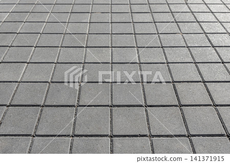 Square concrete pavers form a repeating geometric pattern ideal for urban pavement Square concrete pavers form a repeating geometric pattern ideal for urban pavement 141371915