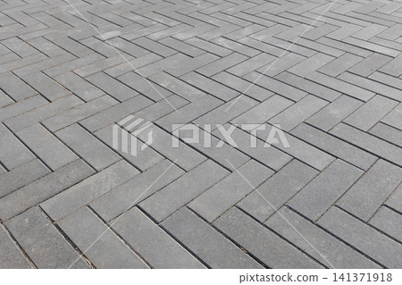 Herringbone pattern of gray concrete pavers, urban background Herringbone pattern of gray concrete pavers, urban background 141371918