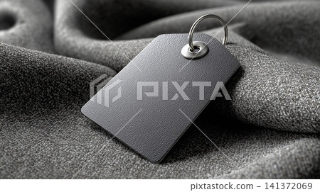 Blank clothing tag mockup on silk fabric with copy space Blank clothing tag mockup on silk fabric with copy space 141372069