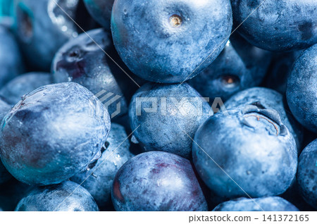 Extreme macro background texture of fresh wet blueberries piled up together in a heap 141372165