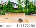 A young man practicing BMX and performing tricks at the skatepark 141372192