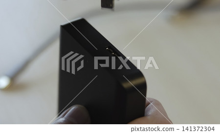 Close Examination Of Connecting Usb Cable Into Black Power Adapter With Focus On Proper Fitting . Media Close Examination Of Connecting Usb Cable Into Black Power Adapter With Focus On Proper Fitting . Media 141372304