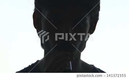 Urban Studio Scene Depicting Introspective Vaper With Gentle Illumination And Subdued Emotional Tone . Media Urban Studio Scene Depicting Introspective Vaper With Gentle Illumination And Subdued Emotional Tone . Media 141372355