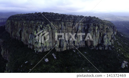 Dramatic Aerial View Of Mossy Flattopped Mountain With Cliffs And Sparse Vegetation At Twilight . Media Dramatic Aerial View Of Mossy Flattopped Mountain With Cliffs And Sparse Vegetation At Twilight . Media 141372469