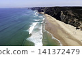 Sea Cliffs Sparkle. Vast Ocean Meets Rugged Shoreline. Bright Sunlight Highlights Shimmering Ocean Waves . Media 141372479