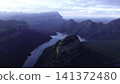 Dawn Over Rugged Cliffs And Flowing Waters. Majestic Canyon River With Mist And Golden Sunlight At Dawn . Media 141372480