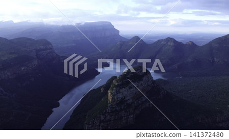Dawn Over Rugged Cliffs And Flowing Waters. Majestic Canyon River With Mist And Golden Sunlight At Dawn . Media 141372480