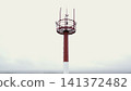 Red and white tower mast against a cloudy sky 141372482